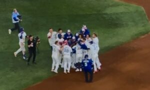 Baseball team in a huddle celebrating victory