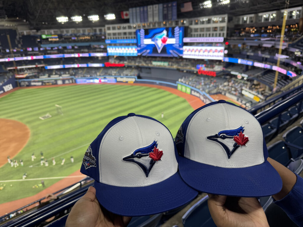 Two baseball hats in a stadium