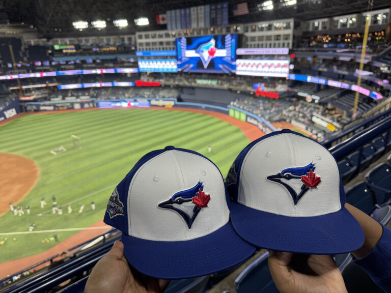 Two baseball hats in a stadium