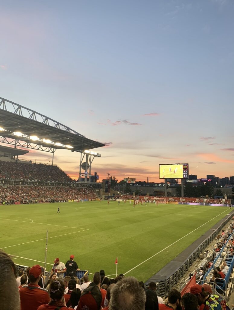 image of a  soccer stadium with sunset in the back 