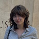 A photo of a women with medium-length brown hair