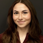 A photo of a woman with brown hair.