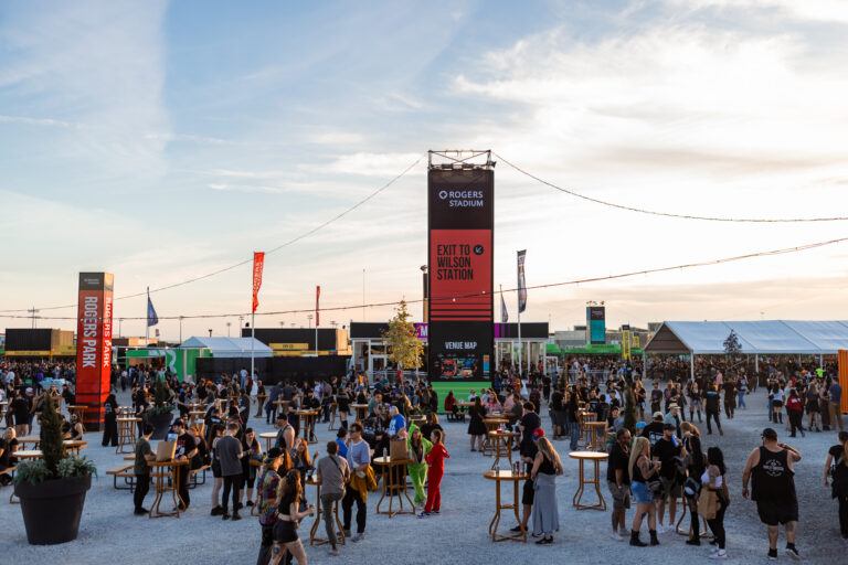A photo of the Rogers Stadium with people spread out throughout the entire part of the venue that can be seen, different vendors are also visible.