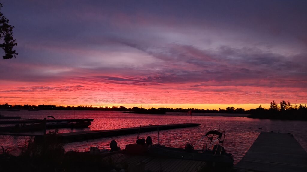 Sunrise over Lake Ontario with docks and boats in the foreground