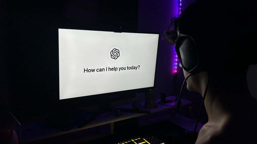 A man on his desktop with ChatGPT on his screen.