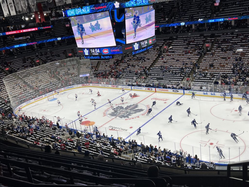 Toronto Maple Leafs and Montreal Canadiens players warm up on the ice at Scotiabank Arena ahead of the Maple Leafs’ home opener.