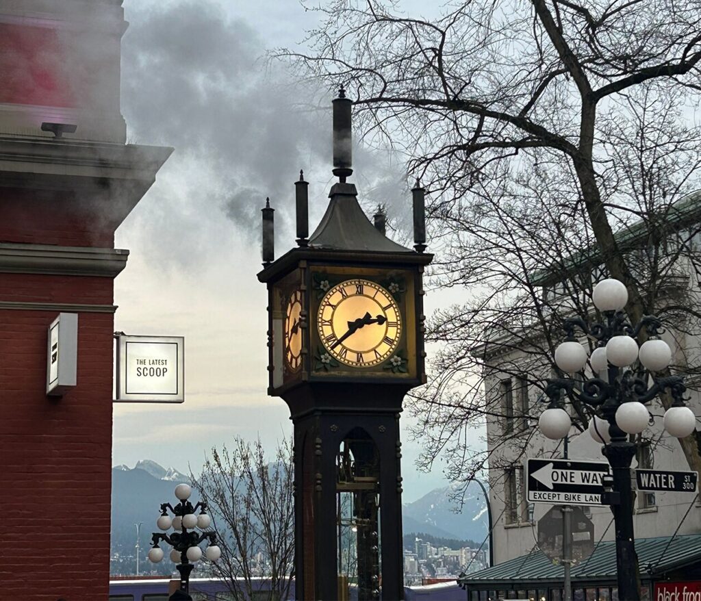 Vintage steam clock with blue sky in the background