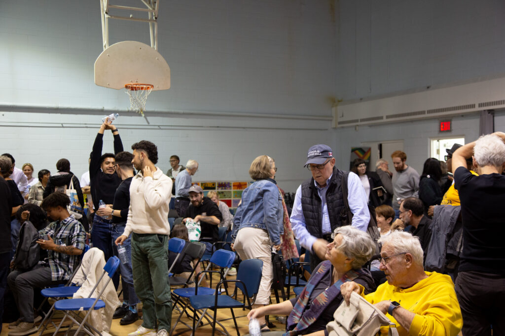 A room filled with people who are moving and stretching.