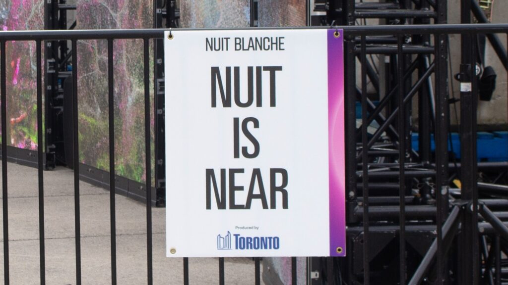 An image with lettering saying “NUIT IS NEAR”