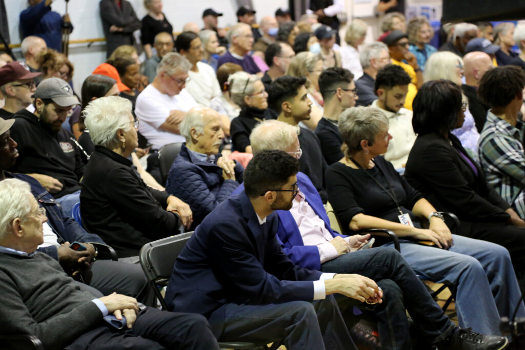People sitting on chairs in a room.