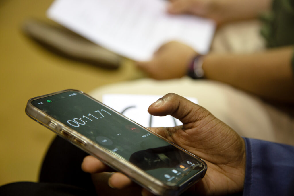 A phone with a timer on it reading “00:11.71”