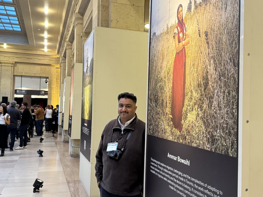Ammar Bowaihl stands beside his portrait (OTR/Mostafa Al-A’sar)