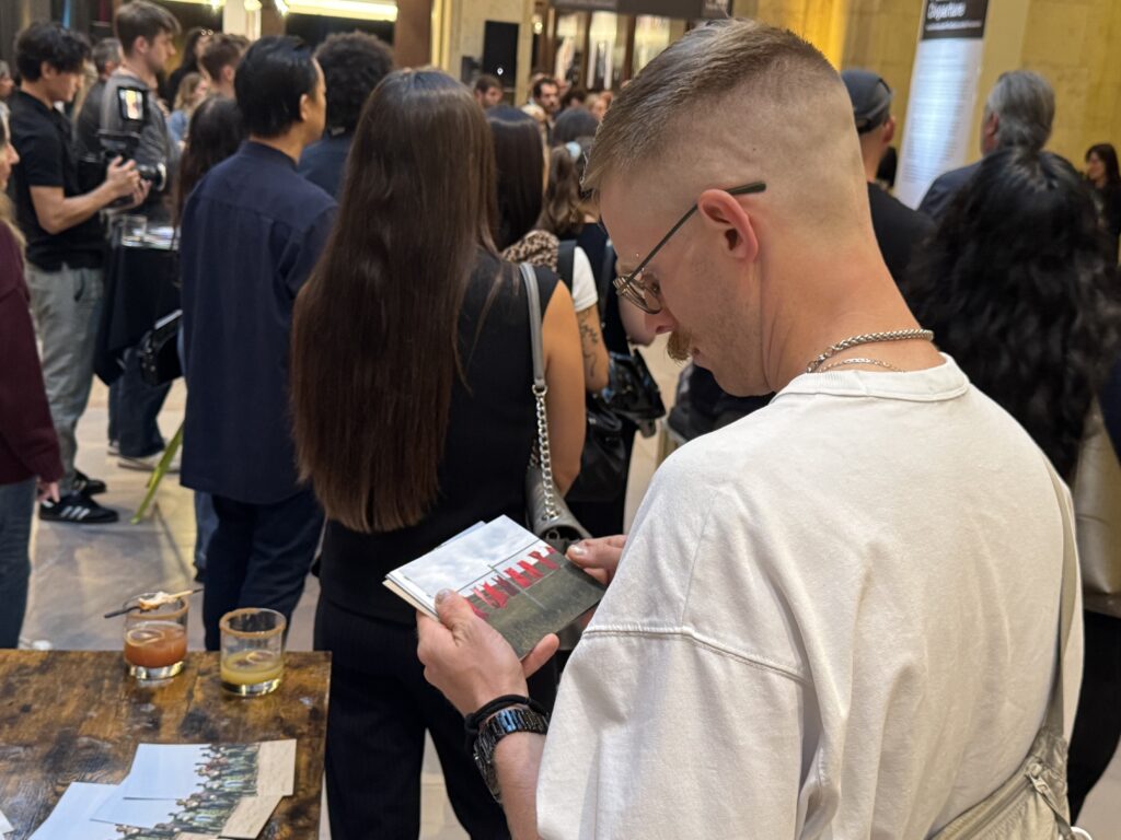 A man looking at Shay’s printed photograph (OTR/Mostafa Al-A’sar)