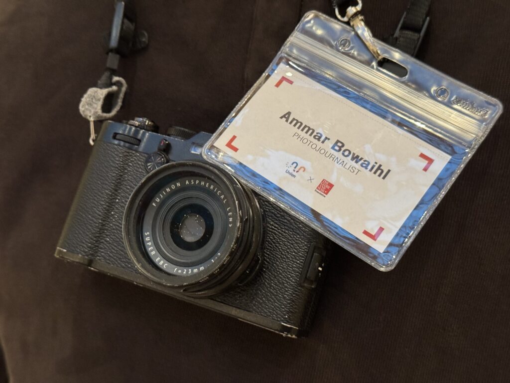 Ammar Bowaihl holds his camera and identification card (OTR/Mostafa Al-A’sar)