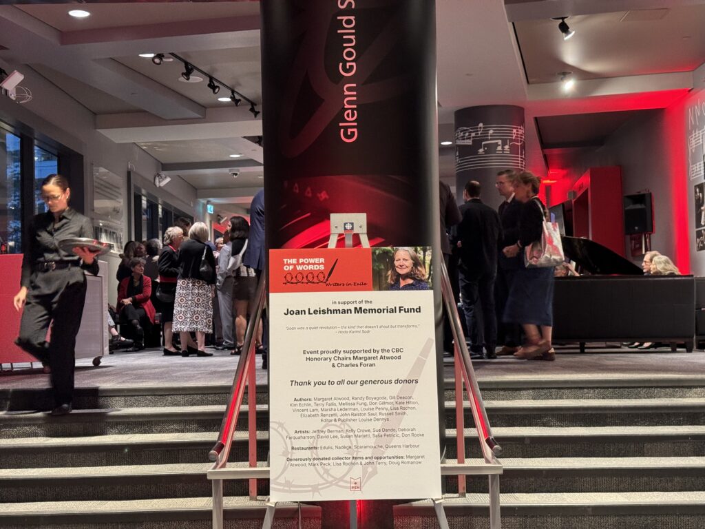 A staircase entrance with a sign for Joan Leishman's memorial fund event