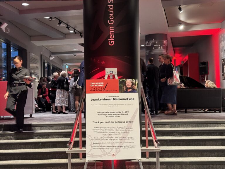 A staircase entrance with a sign for Joan Leishman's memorial fund event